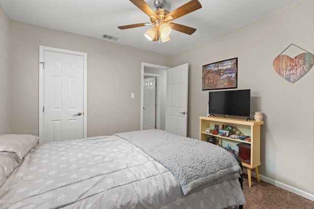 carpeted bedroom with baseboards, visible vents, and a ceiling fan