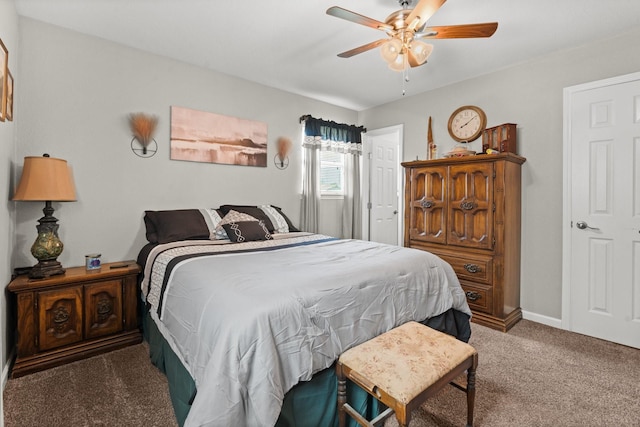 bedroom with a ceiling fan, carpet flooring, and baseboards
