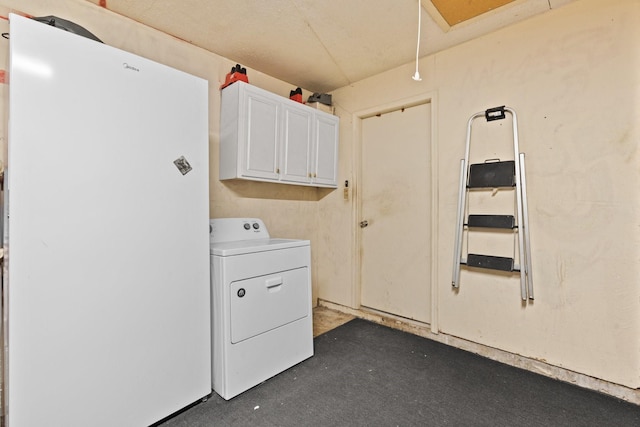 clothes washing area with cabinet space and washer / dryer