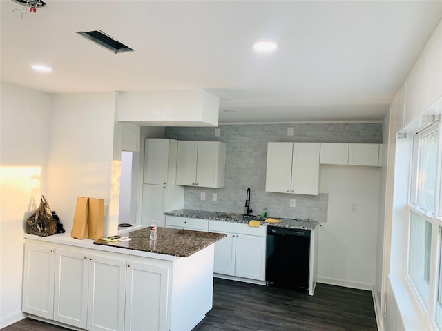 kitchen featuring a sink, black dishwasher, dark wood-type flooring, white cabinetry, and a peninsula