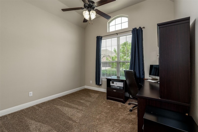 office area featuring vaulted ceiling, baseboards, a ceiling fan, and dark carpet