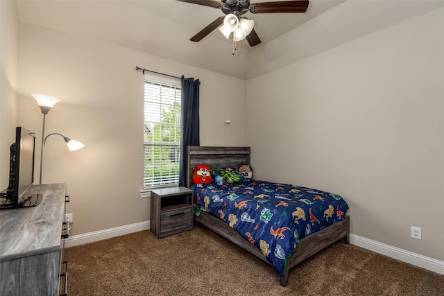bedroom with dark colored carpet, a ceiling fan, and baseboards