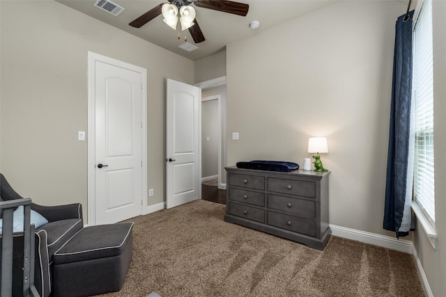living area featuring visible vents, a ceiling fan, carpet, and baseboards