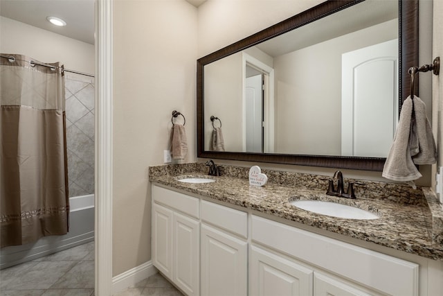 full bathroom featuring double vanity, a sink, marble finish floor, and shower / tub combo