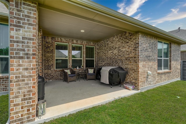 view of patio with area for grilling and an outdoor hangout area