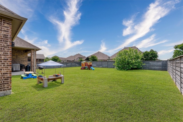 view of yard featuring a fenced backyard and a playground