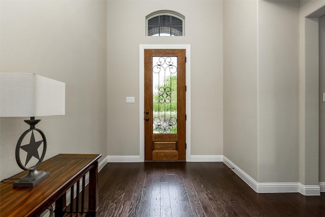 foyer entrance featuring baseboards and wood finished floors