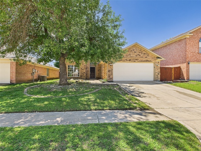 1117 Victoria Dr, Saginaw, TX 76131 - view of property hidden behind natural elements with brick siding, central air condition unit, a garage, driveway, and a front yard