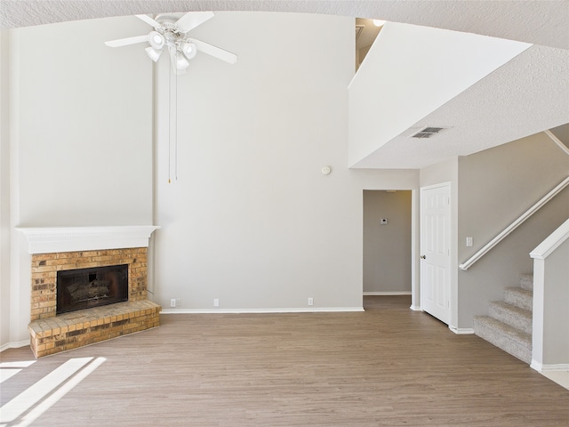 1117 Victoria Dr, Saginaw, TX 76131 - unfurnished living room featuring visible vents, ceiling fan, baseboards, wood finished floors, and stairs
