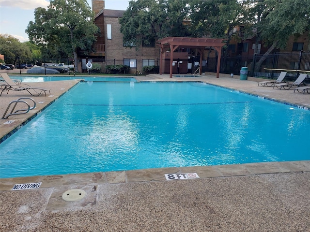 pool with fence and a patio
