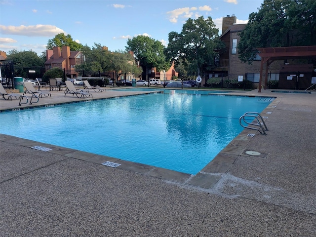pool featuring fence and a patio area