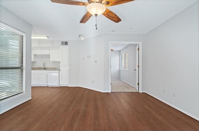 unfurnished living room featuring ceiling fan, visible vents, baseboards, and dark wood-type flooring