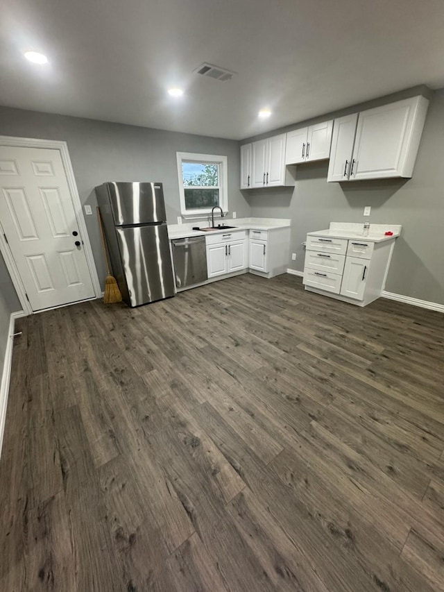 kitchen featuring visible vents, baseboards, appliances with stainless steel finishes, and dark wood finished floors