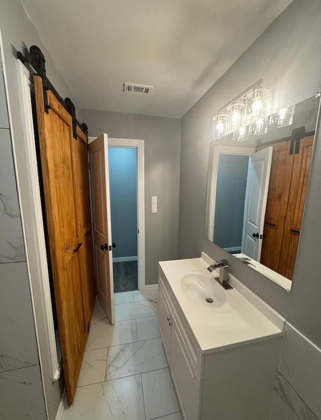 bathroom featuring baseboards, visible vents, vanity, and marble finish floor