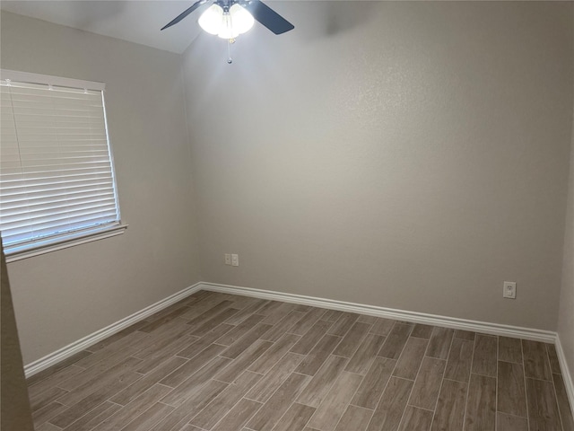 unfurnished room with ceiling fan, wood finished floors, and baseboards