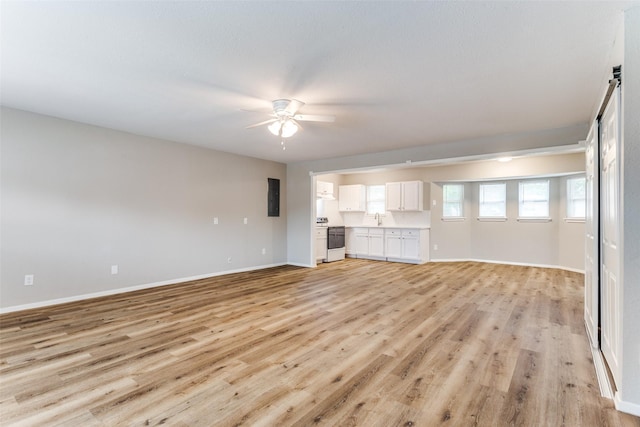 1601 Winderemere Dr, Arlington, TX 76014 - unfurnished living room with a sink, baseboards, light wood-type flooring, electric panel, and a ceiling fan