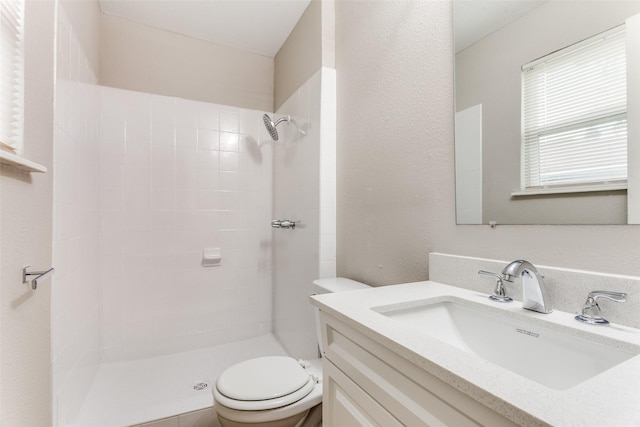1601 Winderemere Dr, Arlington, TX 76014 - bathroom featuring toilet, tiled shower, and vanity