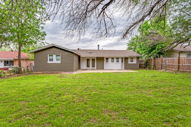 1601 Winderemere Dr, Arlington, TX 76014 - back of property with a lawn, a fenced backyard, a patio area, and french doors