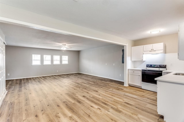 1601 Winderemere Dr, Arlington, TX 76014 - kitchen featuring range with electric stovetop, light countertops, light wood-style floors, and under cabinet range hood