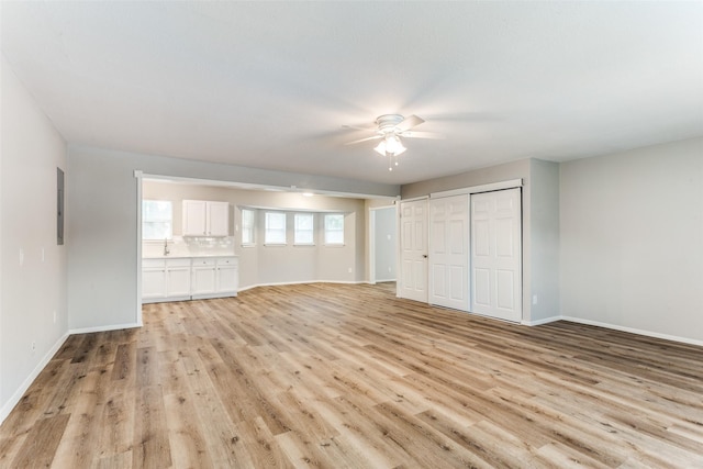 1601 Winderemere Dr, Arlington, TX 76014 - unfurnished bedroom featuring a closet, light wood-style floors, baseboards, ceiling fan, and electric panel