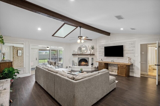 living area featuring lofted ceiling with beams, a brick fireplace, dark wood-type flooring, a ceiling fan, and visible vents
