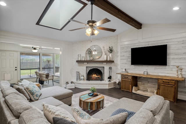 living area with a fireplace, lofted ceiling with beams, a ceiling fan, and dark wood-style floors