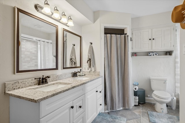 bathroom with double vanity, curtained shower, toilet, and a sink