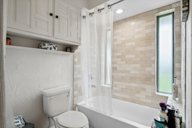full bath featuring toilet and shower / tub combo with curtain