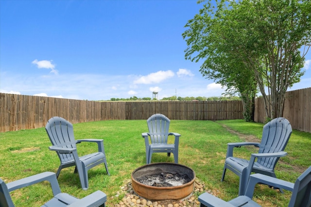view of yard featuring a fenced backyard and an outdoor fire pit