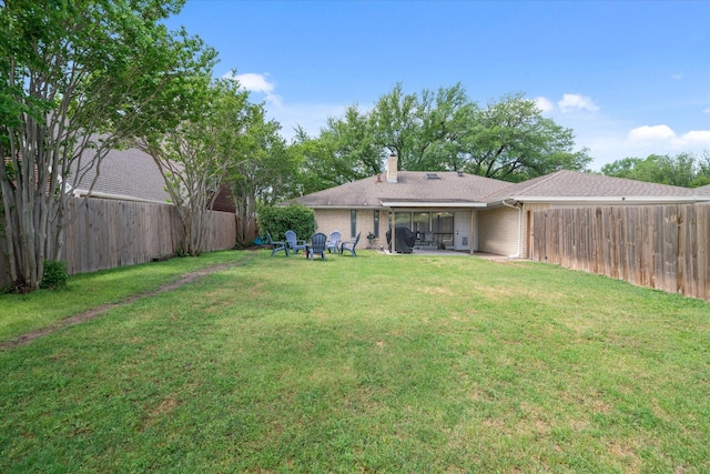view of yard featuring a patio, an outdoor fire pit, and a fenced backyard