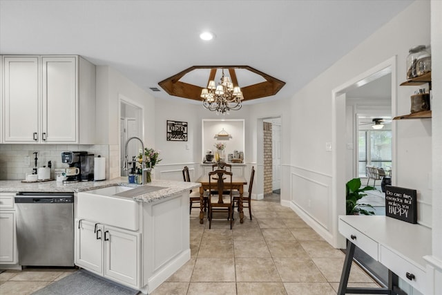 kitchen with a sink, visible vents, an inviting chandelier, dishwasher, and a peninsula