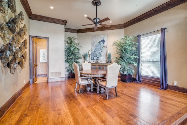dining area featuring crown molding, ceiling fan, light wood-style floors, baseboards, and visible vents