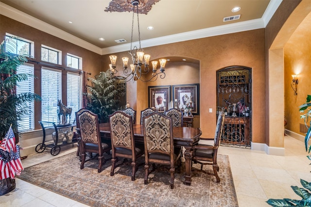dining space with visible vents, crown molding, and a chandelier