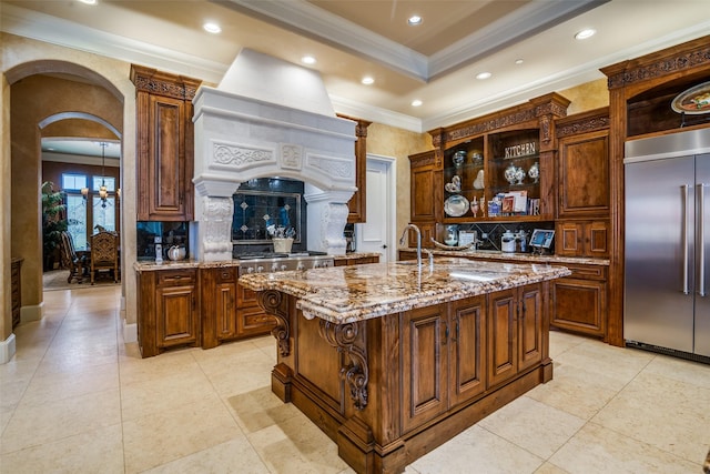 kitchen with crown molding, decorative backsplash, open shelves, and stainless steel built in refrigerator