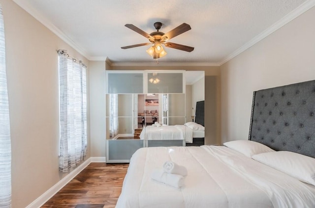 bedroom featuring wood finished floors, a ceiling fan, ornamental molding, and baseboards