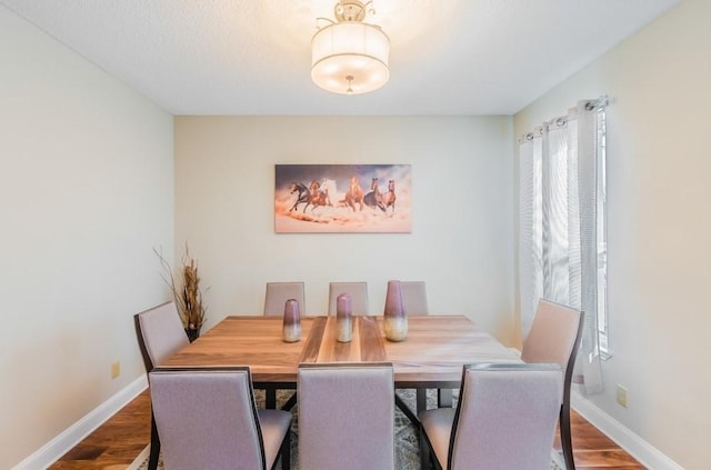 dining area with wood finished floors and baseboards