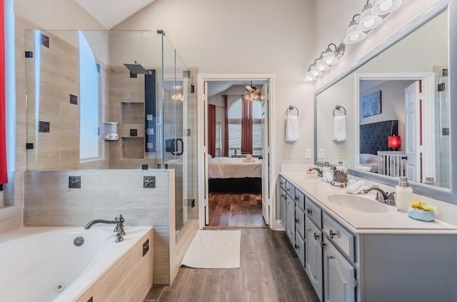 ensuite bathroom featuring wood finished floors, a bath, ensuite bath, and a sink