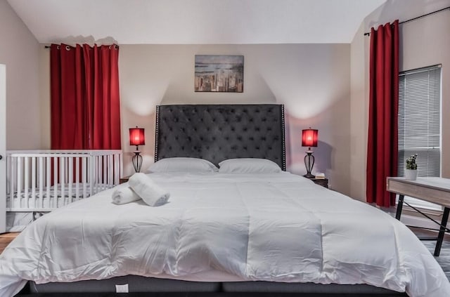 bedroom featuring vaulted ceiling and wood finished floors