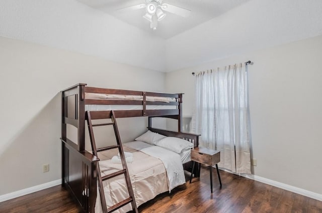 bedroom featuring baseboards, wood finished floors, ceiling fan, and lofted ceiling