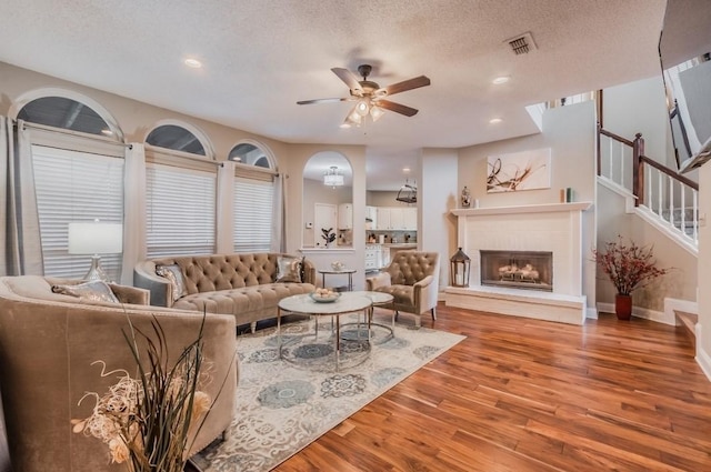 living area featuring recessed lighting, a ceiling fan, visible vents, and wood finished floors