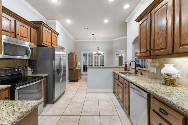 kitchen featuring a sink, appliances with stainless steel finishes, a chandelier, visible vents, and backsplash