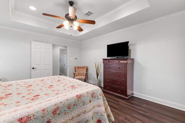 bedroom with a raised ceiling, visible vents, baseboards, ornamental molding, and dark wood finished floors