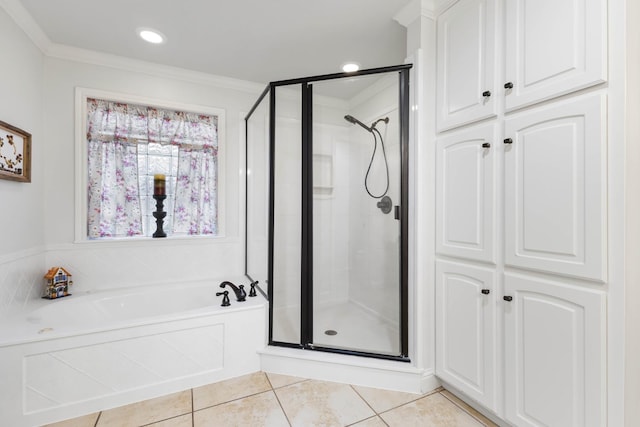 bathroom featuring ornamental molding, a bath, tile patterned flooring, and a stall shower