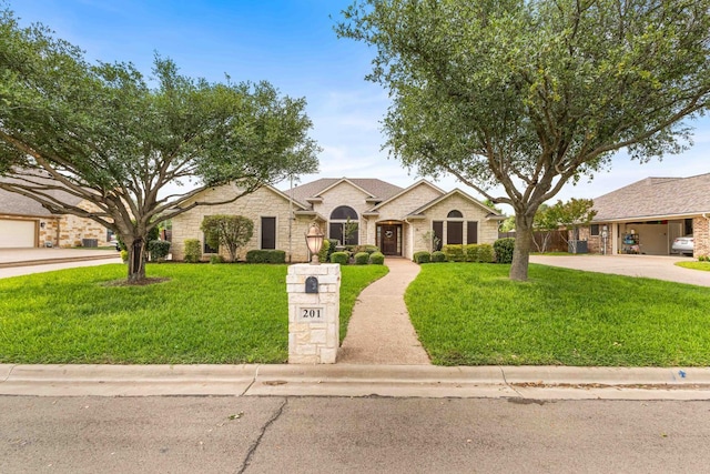 view of front of home with a front yard and stone siding