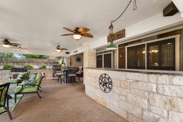 view of patio / terrace featuring fence, ceiling fan, and outdoor dining area