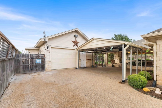 view of front of property featuring driveway, a carport, a gate, fence, and a garage