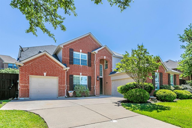 traditional-style house with concrete driveway, a garage, brick siding, and fence