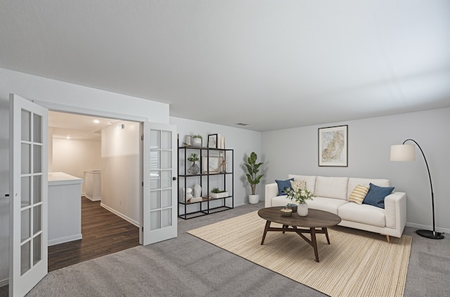 carpeted living room featuring french doors and baseboards