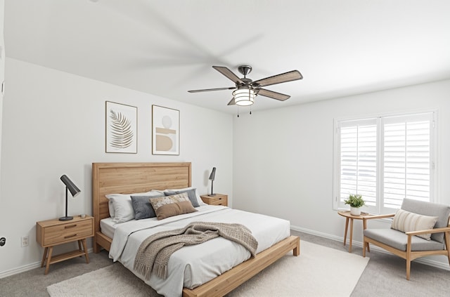 bedroom with a ceiling fan, carpet flooring, and baseboards