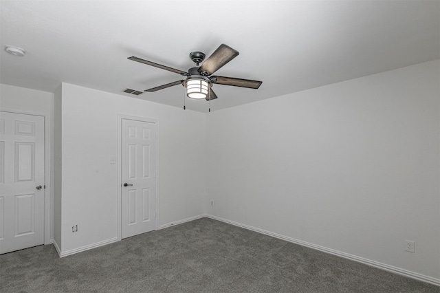 unfurnished bedroom with carpet flooring, a ceiling fan, visible vents, and baseboards